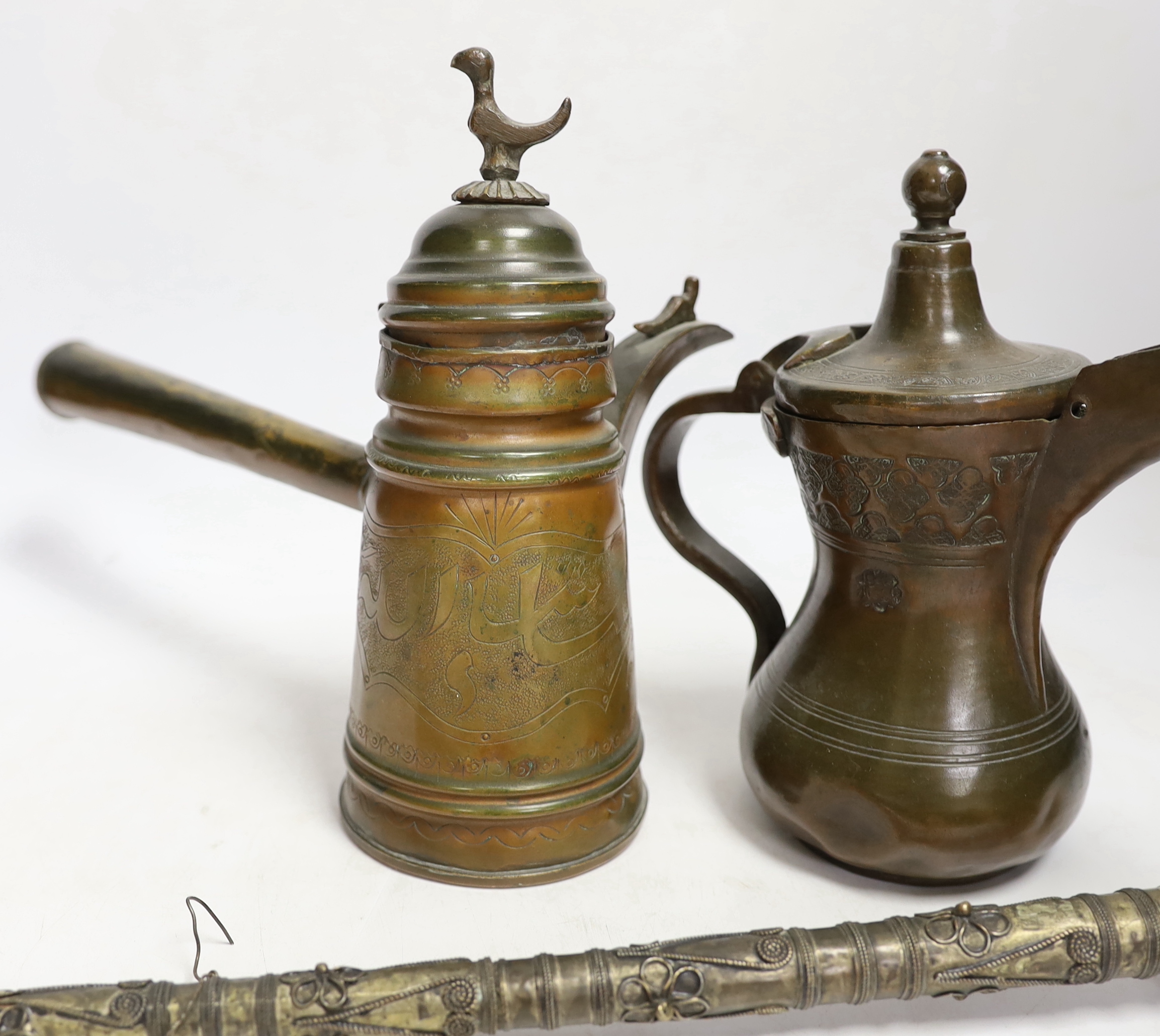 Two Indian opium pipes and two Dallah coffee pots, tallest pot 22cm